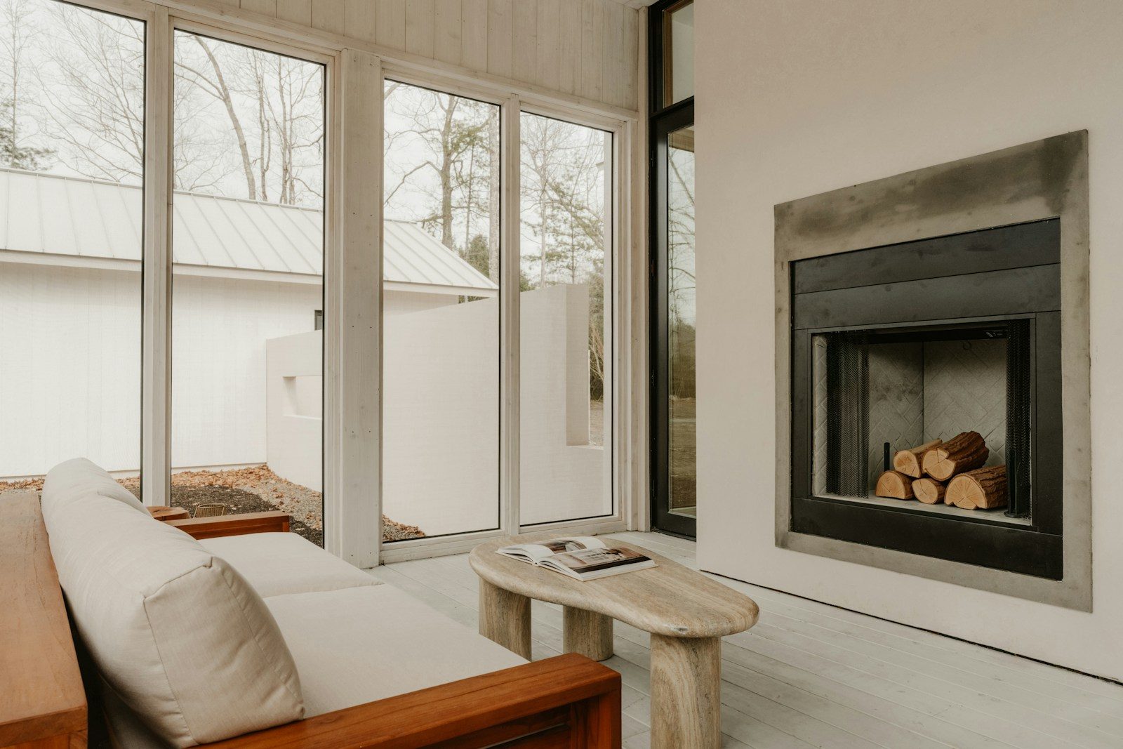 Modern living room with fireplace and large windows
