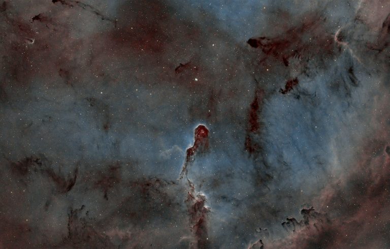 Cosmic nebula with dark pillars of gas and dust.