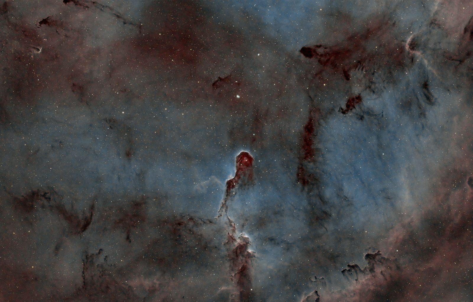 Cosmic nebula with dark pillars of gas and dust.